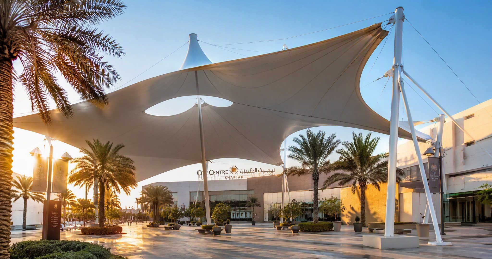 Tensile membrane shade structure installed by Al Hamra Industries over a public plaza in Sharjah, UAE